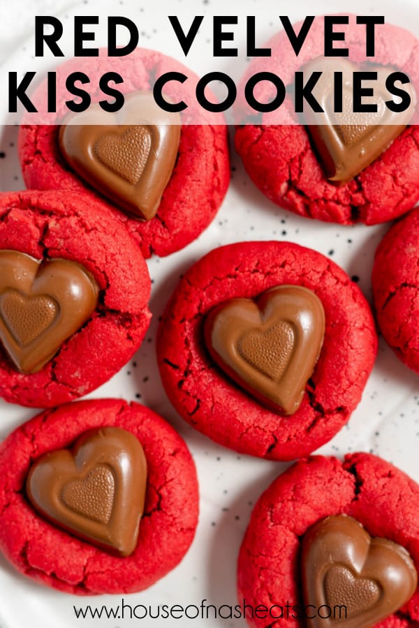 A close image of red velvet cookies with chocolate hearts pressed into their tops with text overlay.