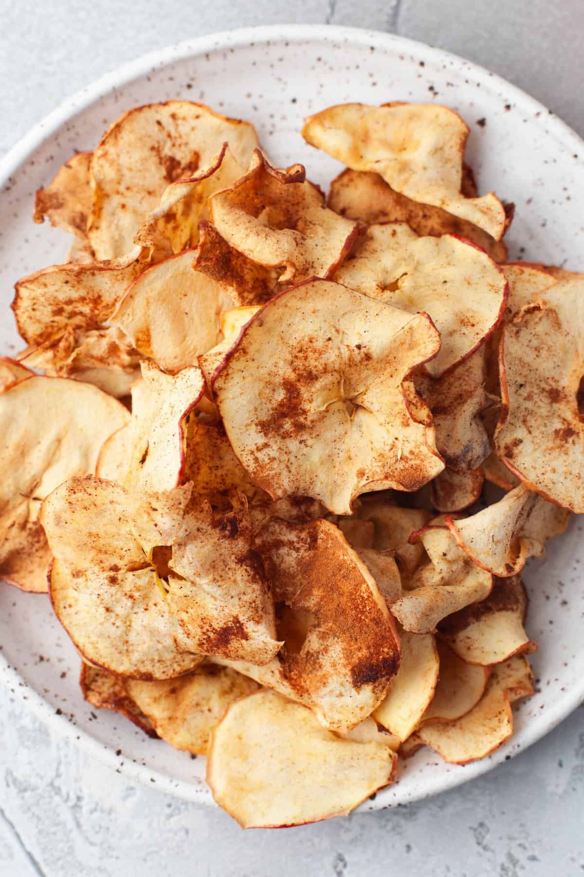 Crisp apple chips on a plate.