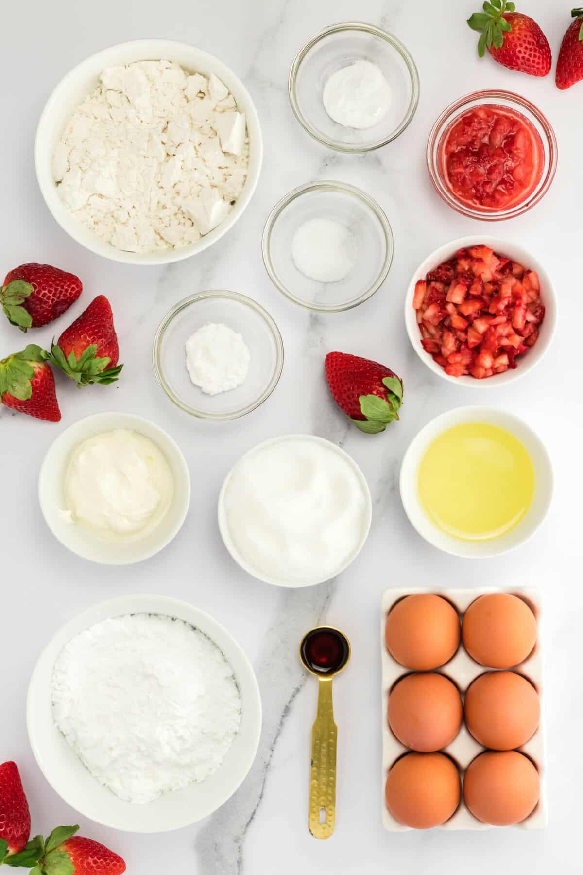 Top view of ingredients needed to make baked strawberry donuts.