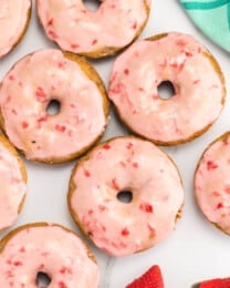 Top view of baked strawberry donuts on a table.