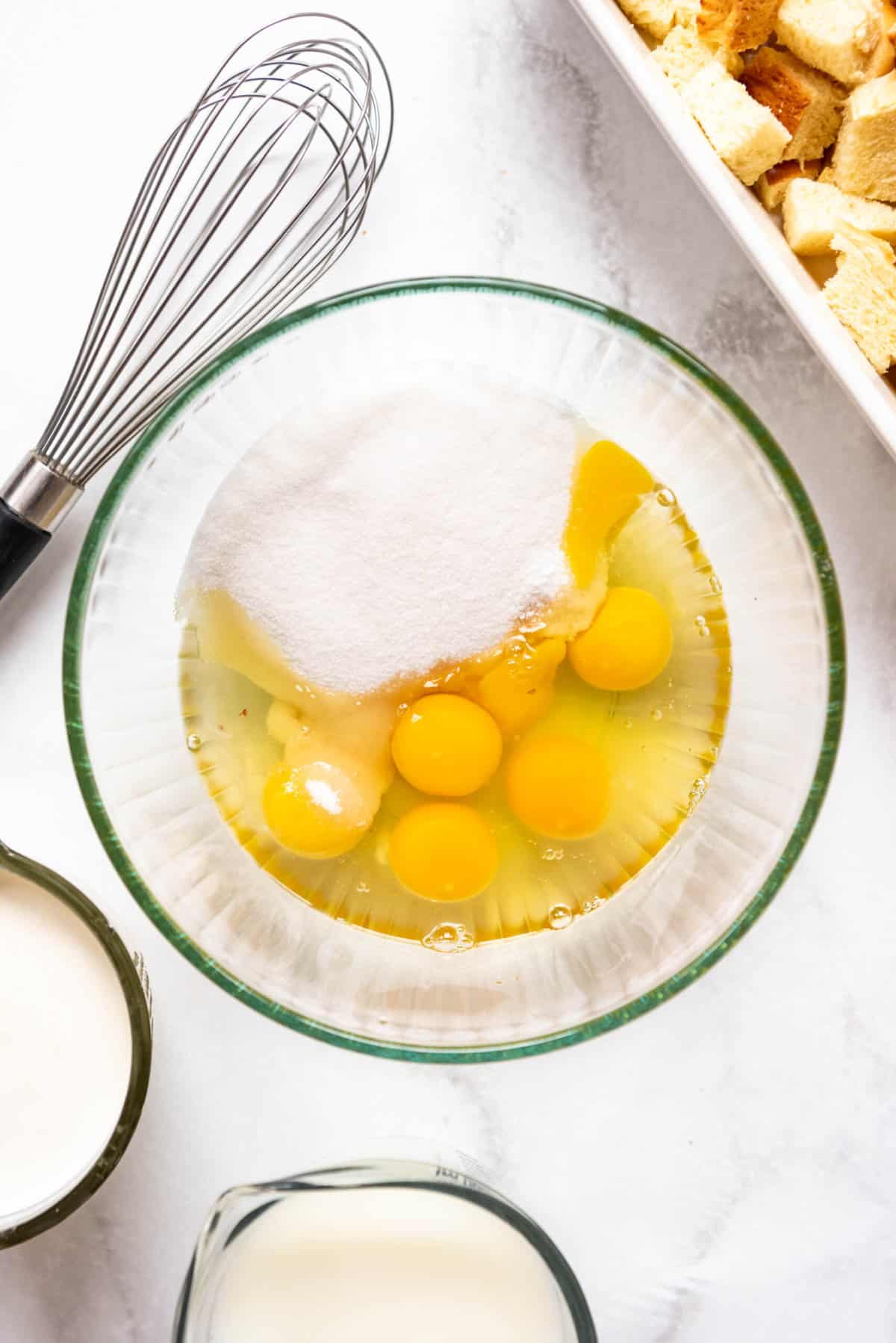 Combining eggs and sugar in a large bowl.
