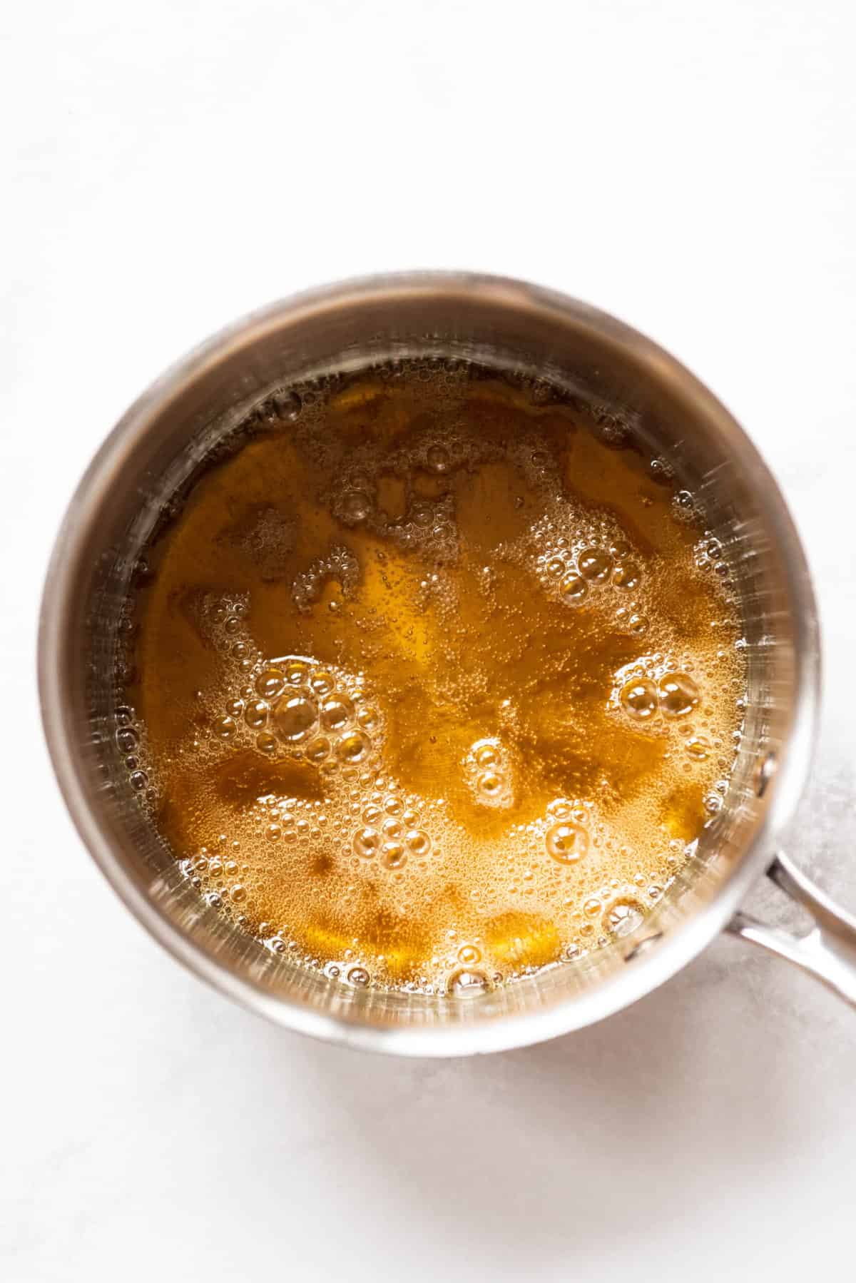 Molten sugar in a saucepan for making caramel sauce.