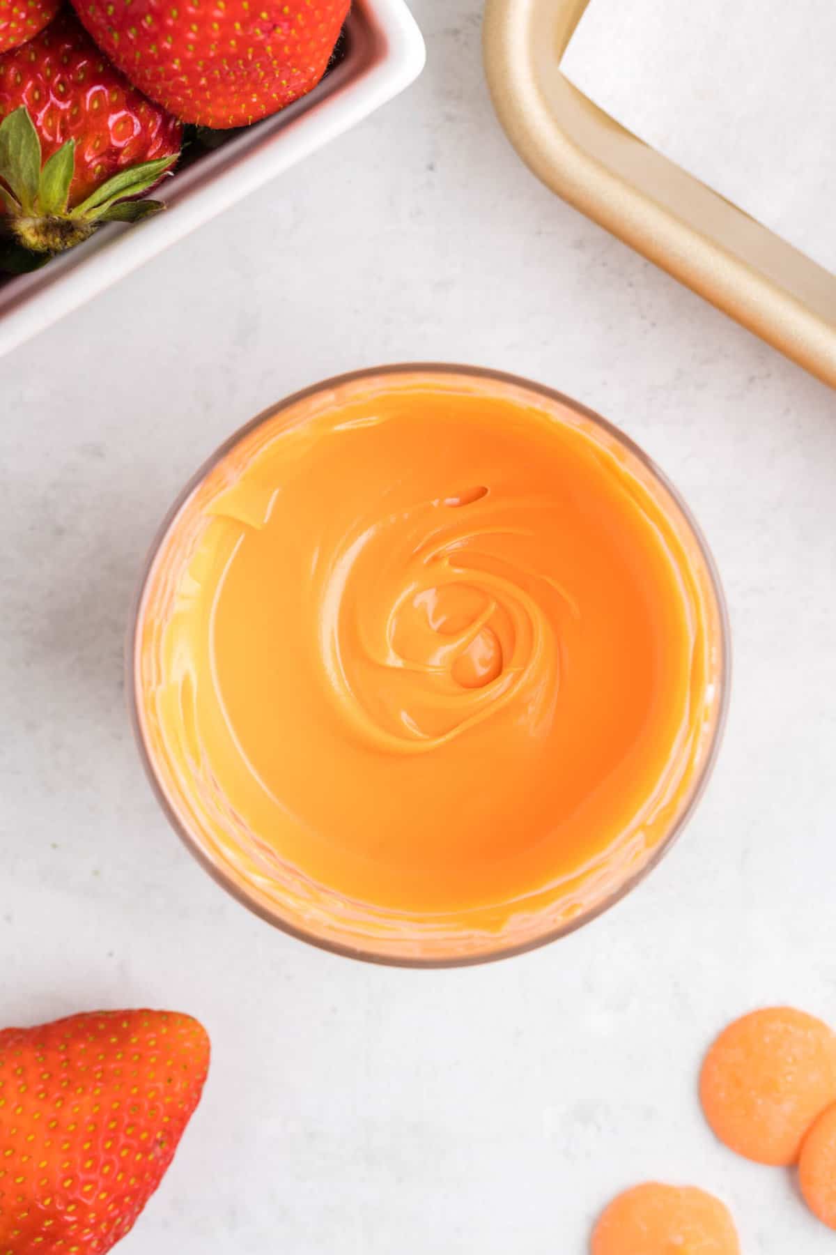 Melted orange candy melts in a bowl.