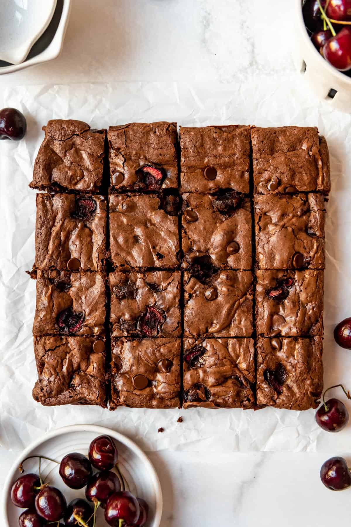 Cherry brownies cut into sixteen squares.