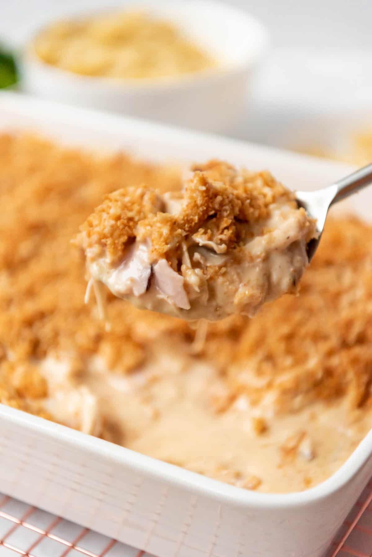 A large spoonful of chicken and ham cordon bleu casserole made with rotisserie chicken.