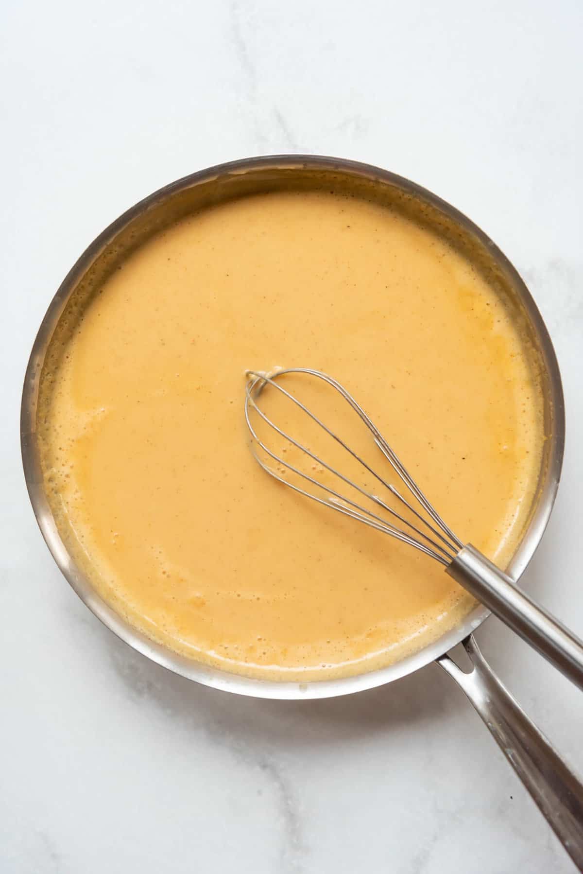 A thickened sauce made with roux, spices, chicken broth, and milk.