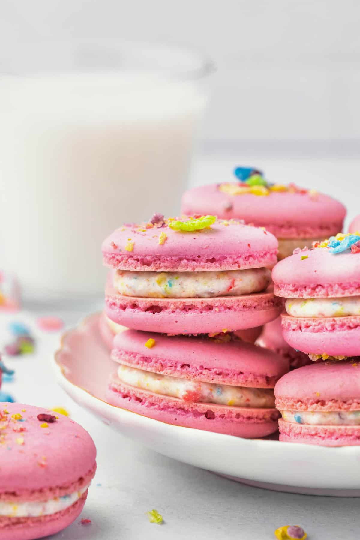 Fruity Pebbles macarons stacked on a plate.