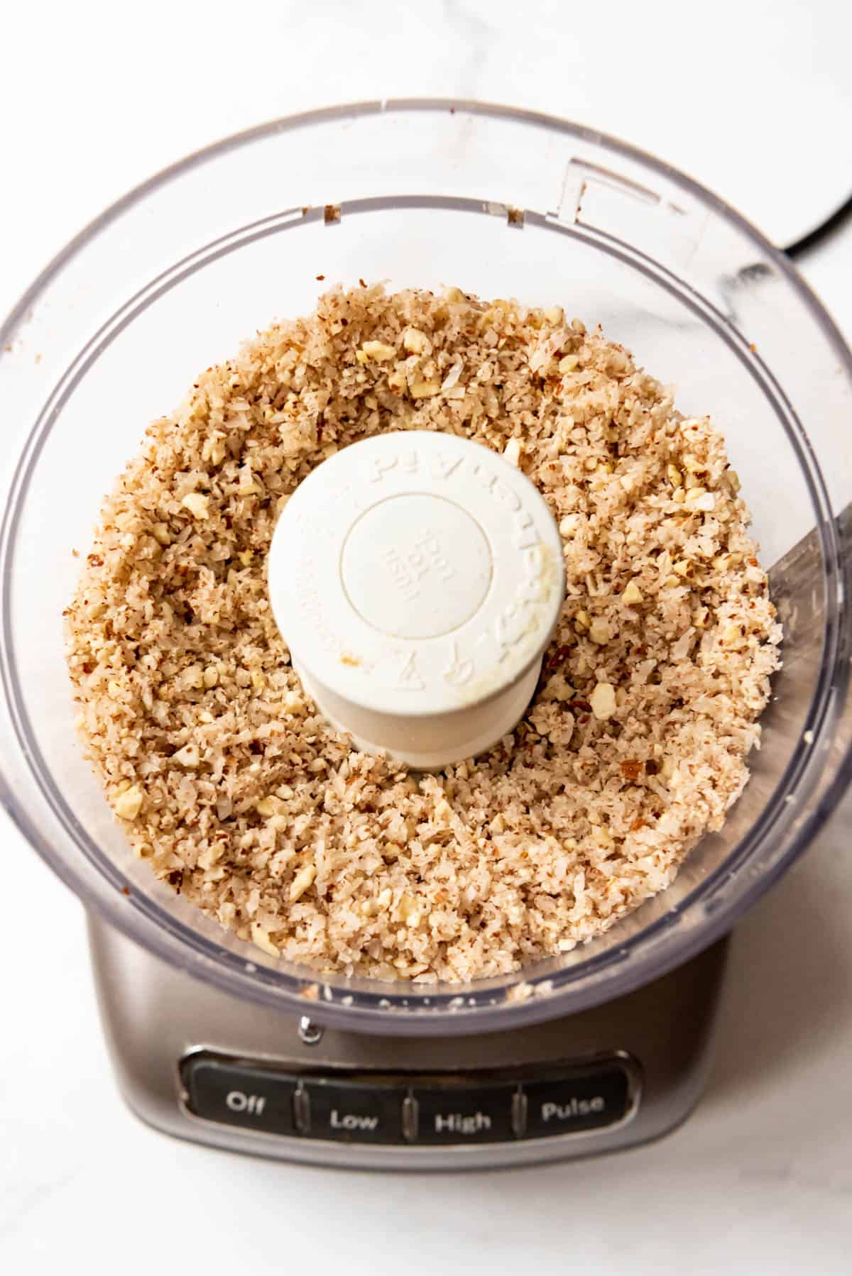 Finely chopped coconut and almonds in a food processor.