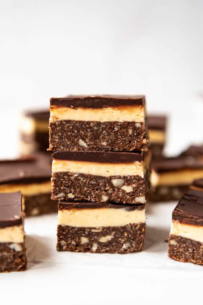 Three nanaimo bars stacked on top of each other.