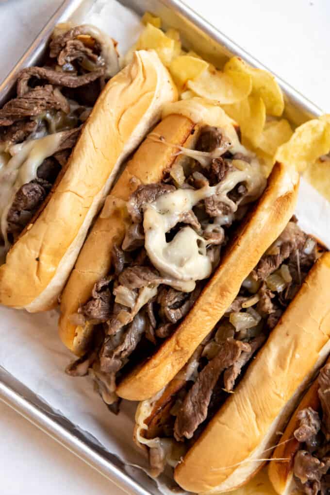 Melted cheese on a Philly cheese steak sandwich.