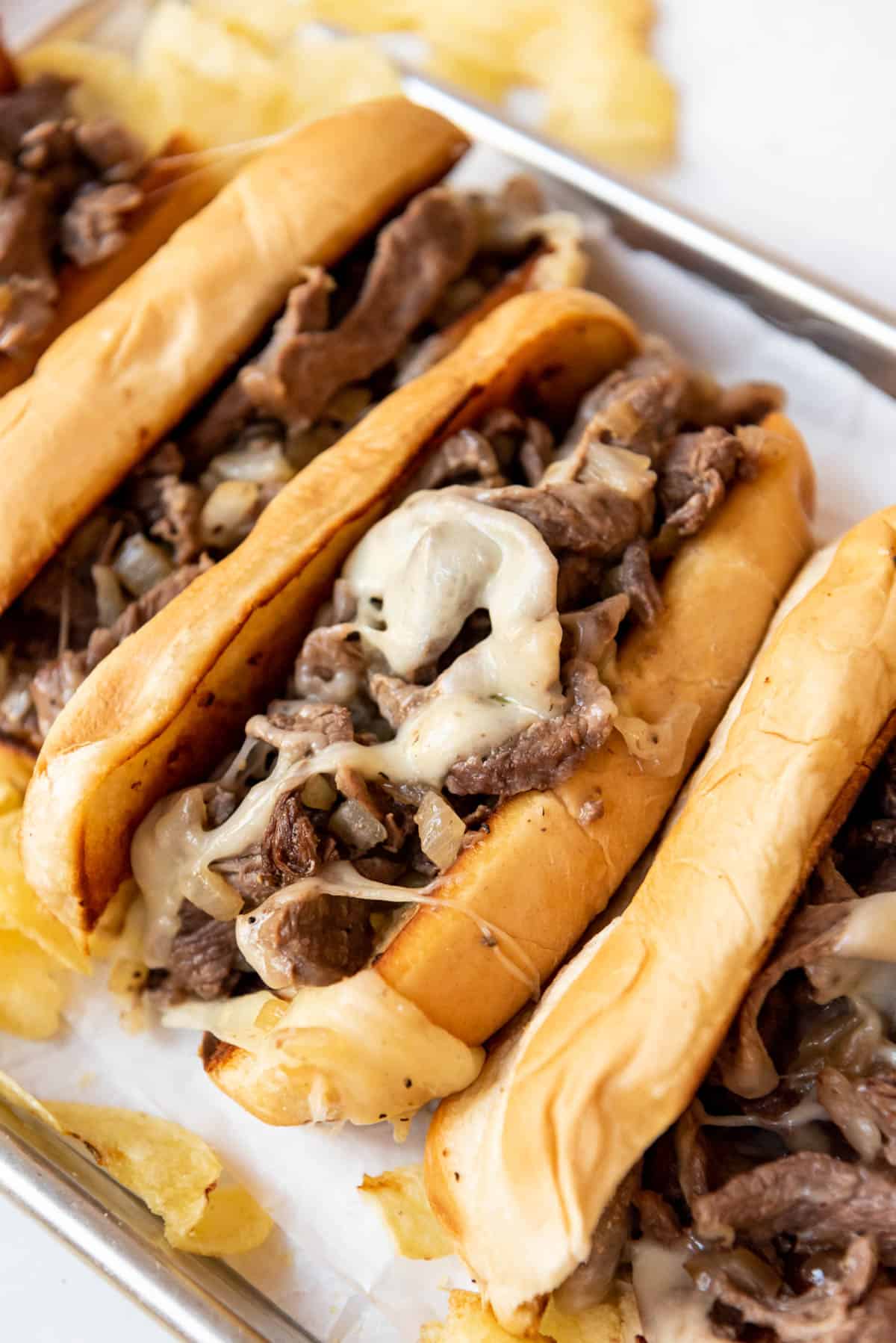 Soft hoagie rolls filled with Philly cheese steak filling.