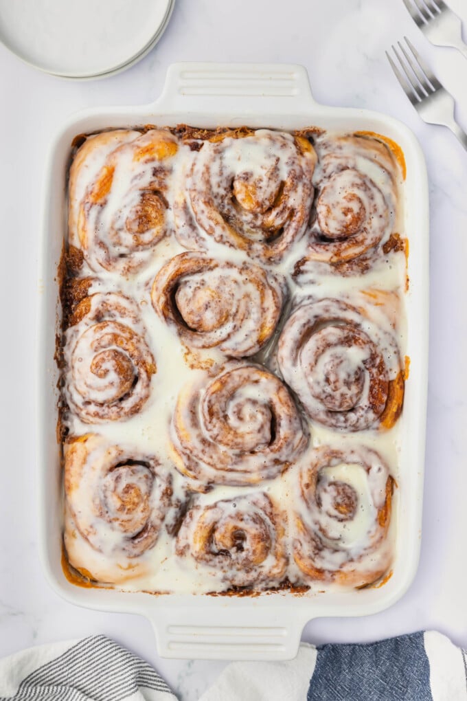 TikTok cinnamon rolls in a pan after the frosting has been added.