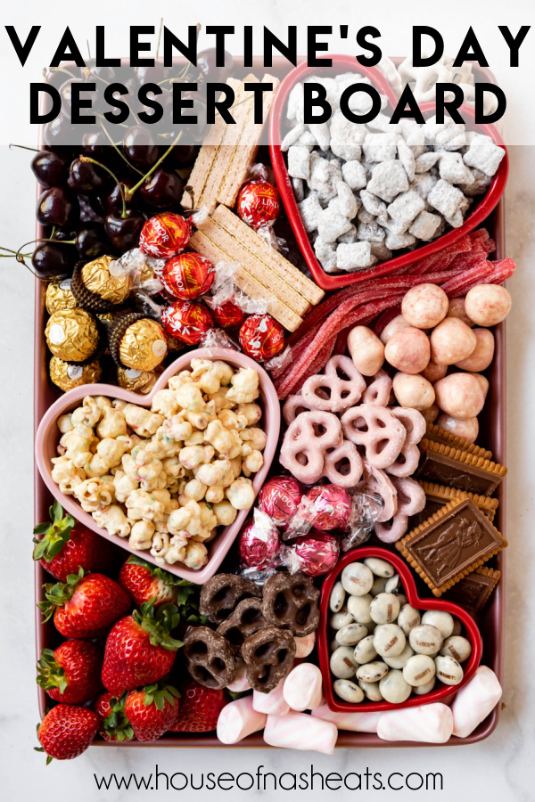 A Valentine's Day dessert board with cookies, candy, pretzels, and popcorn with text overlay.