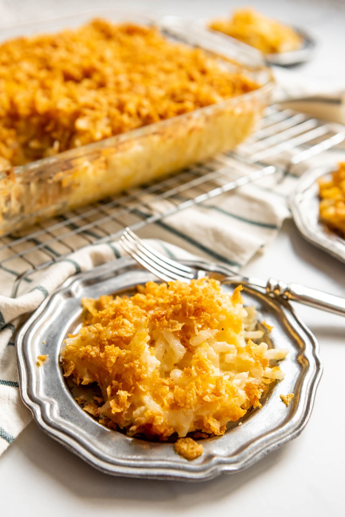 A scoop of funeral potatoes on a plate.