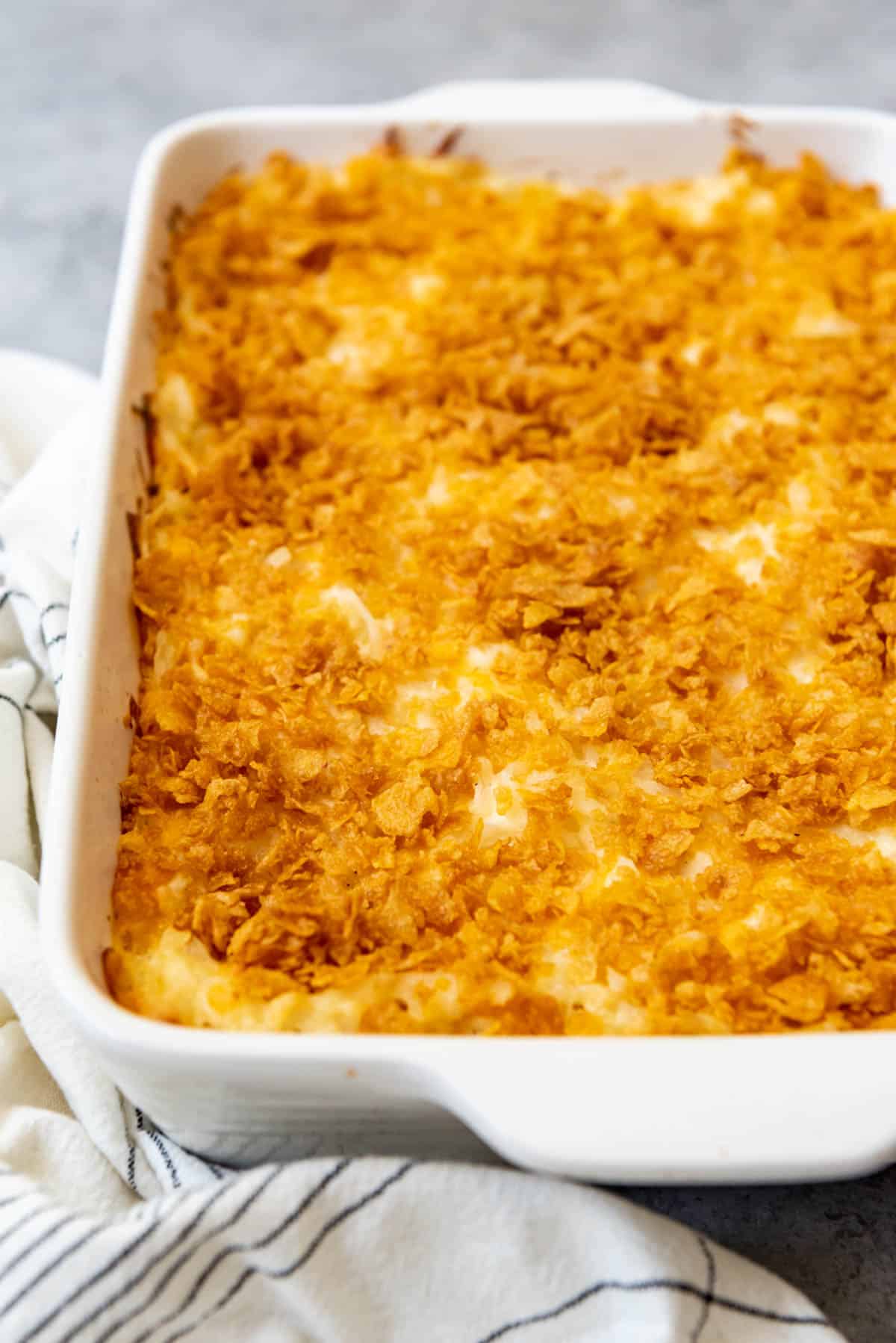 Funeral potatoes topped with buttery corn flakes.