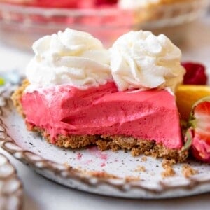 A slice of kool-aid pie with whipped cream on top.