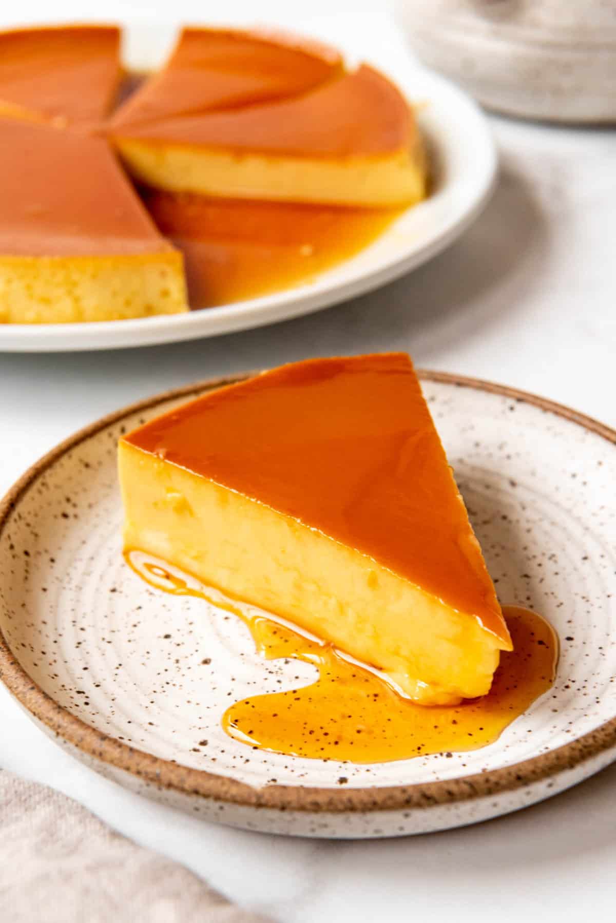 Close up of a slice of Mexican flan.