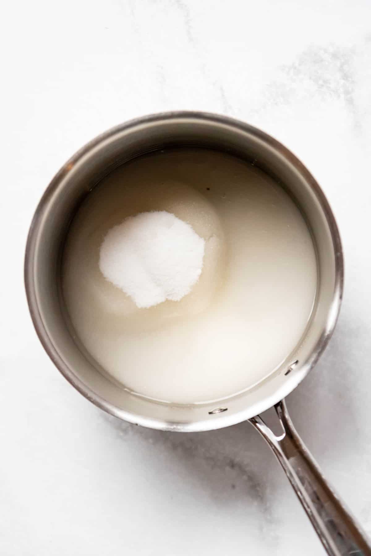 Top view of a pan with sugar and water in it. 