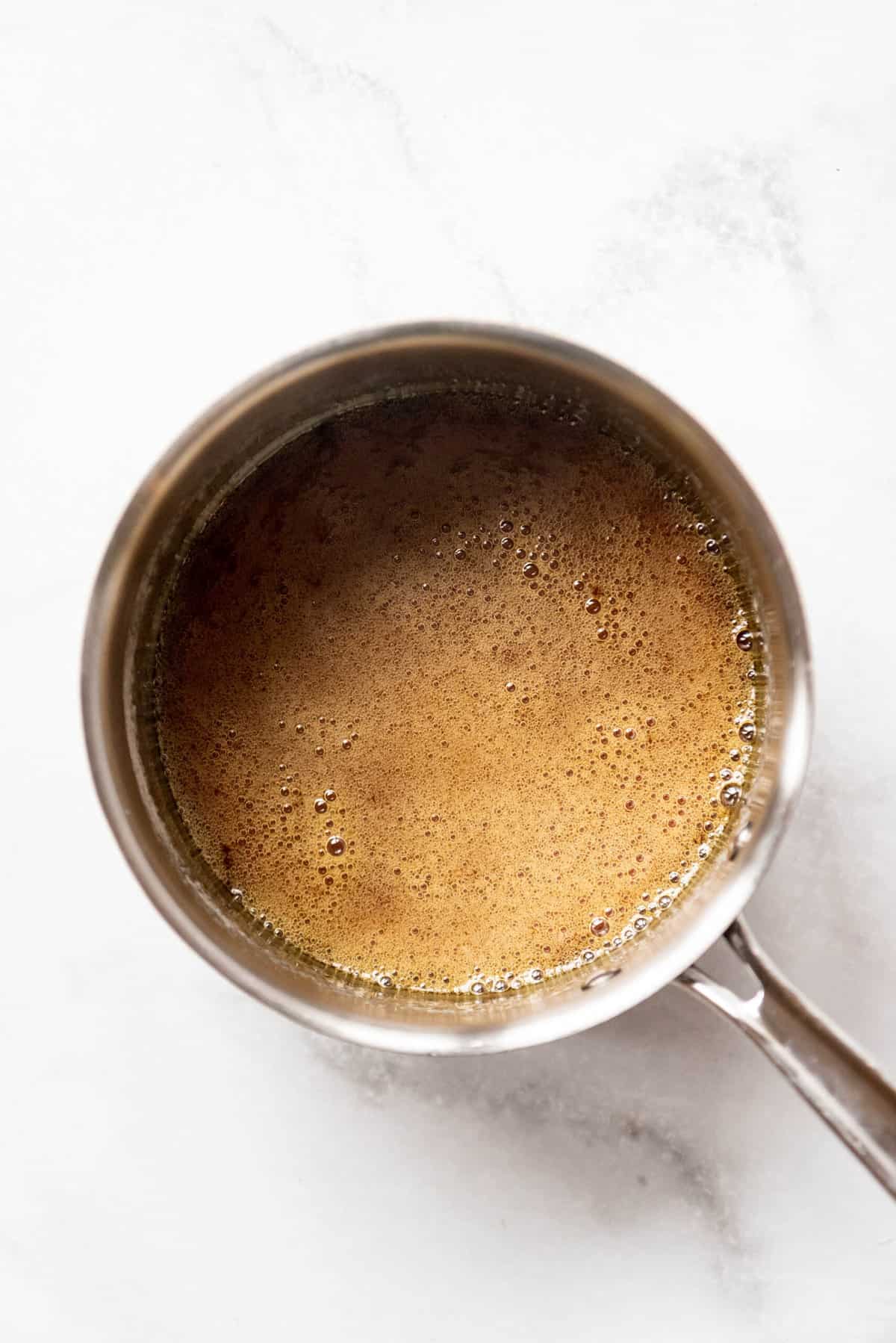 Top view of pan with a brown bubbling mixture in it.