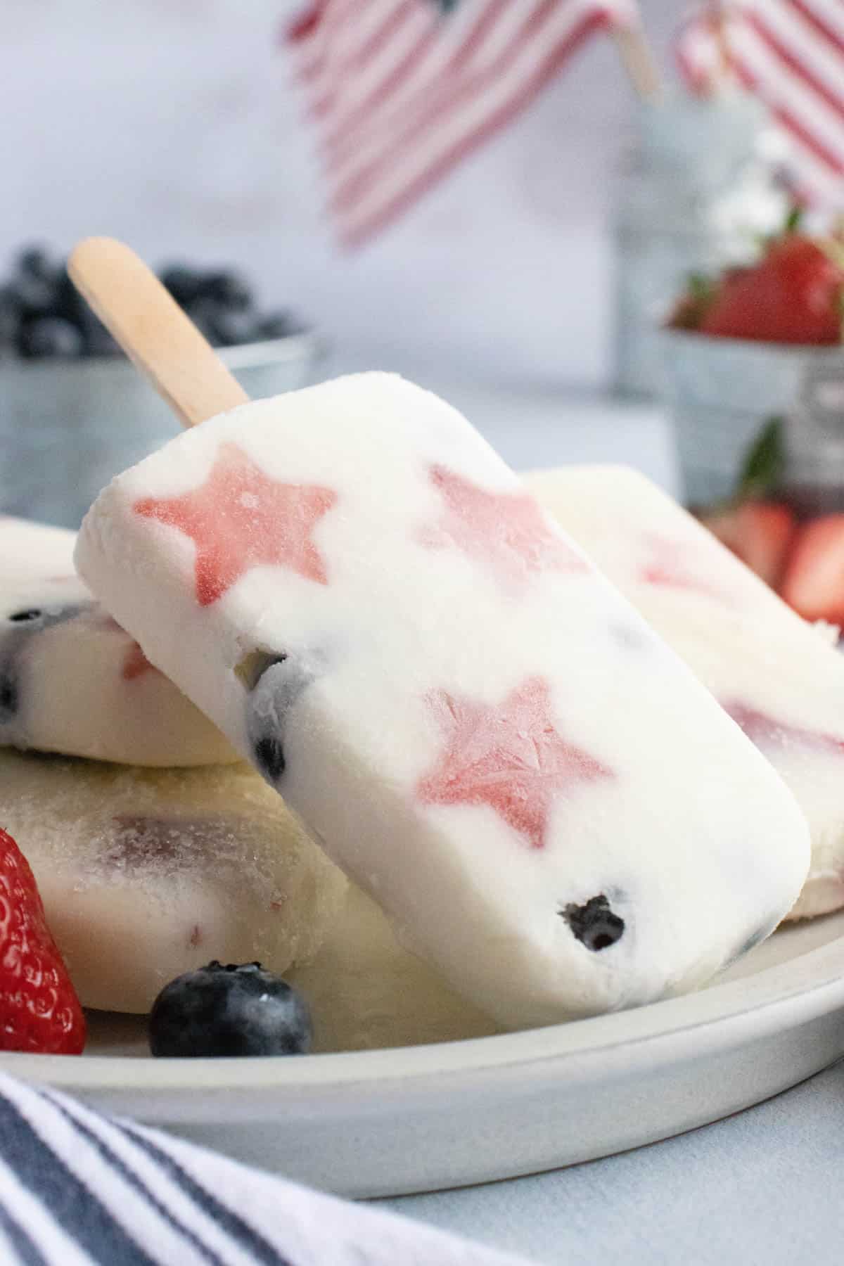 A creamy yogurt popsicle with strawberry stars and blueberries.