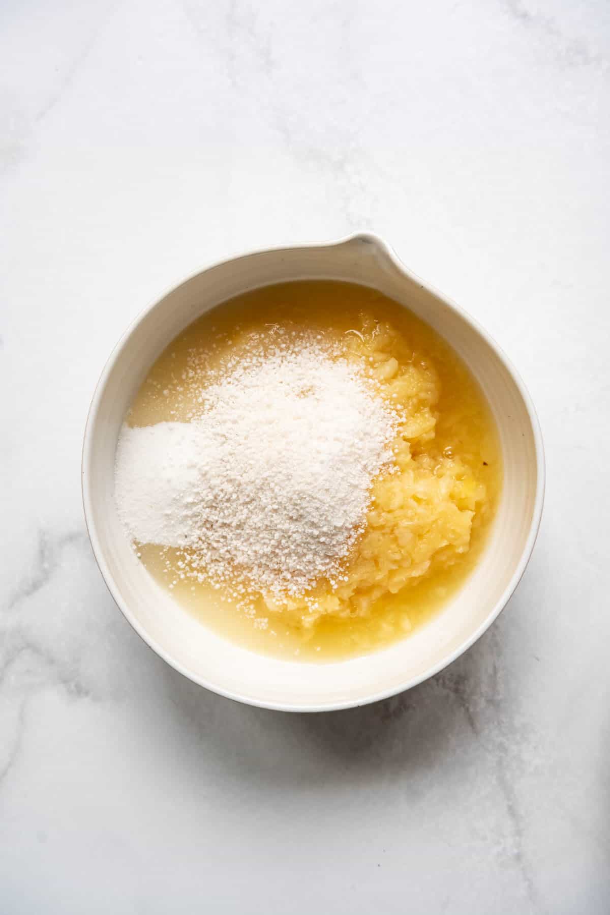 Combining crushed pineapple, sugar, and tapioca in a bowl for pineapple pie filling.