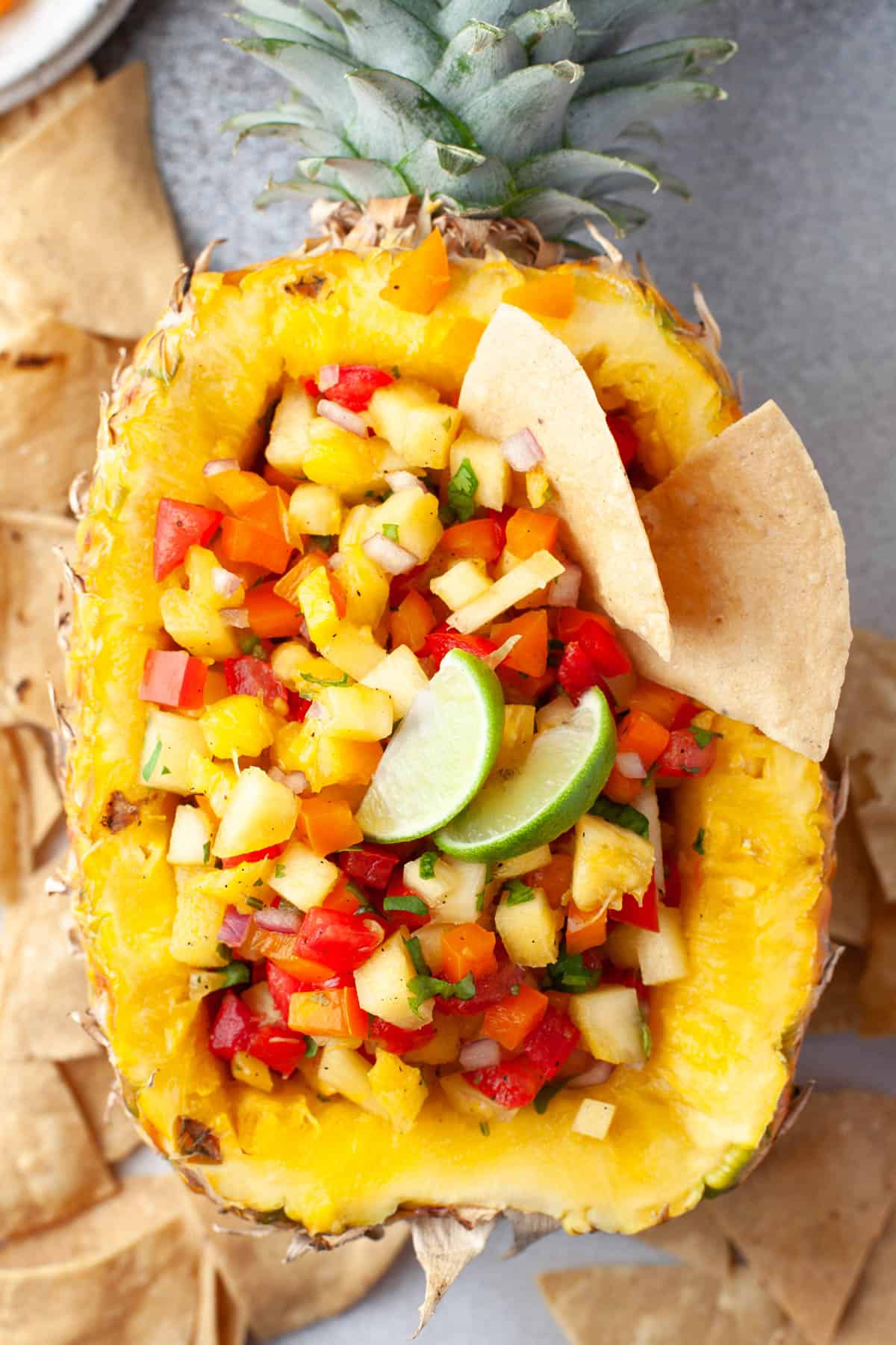 A hollowed out pineapple with pineapple salsa in it.