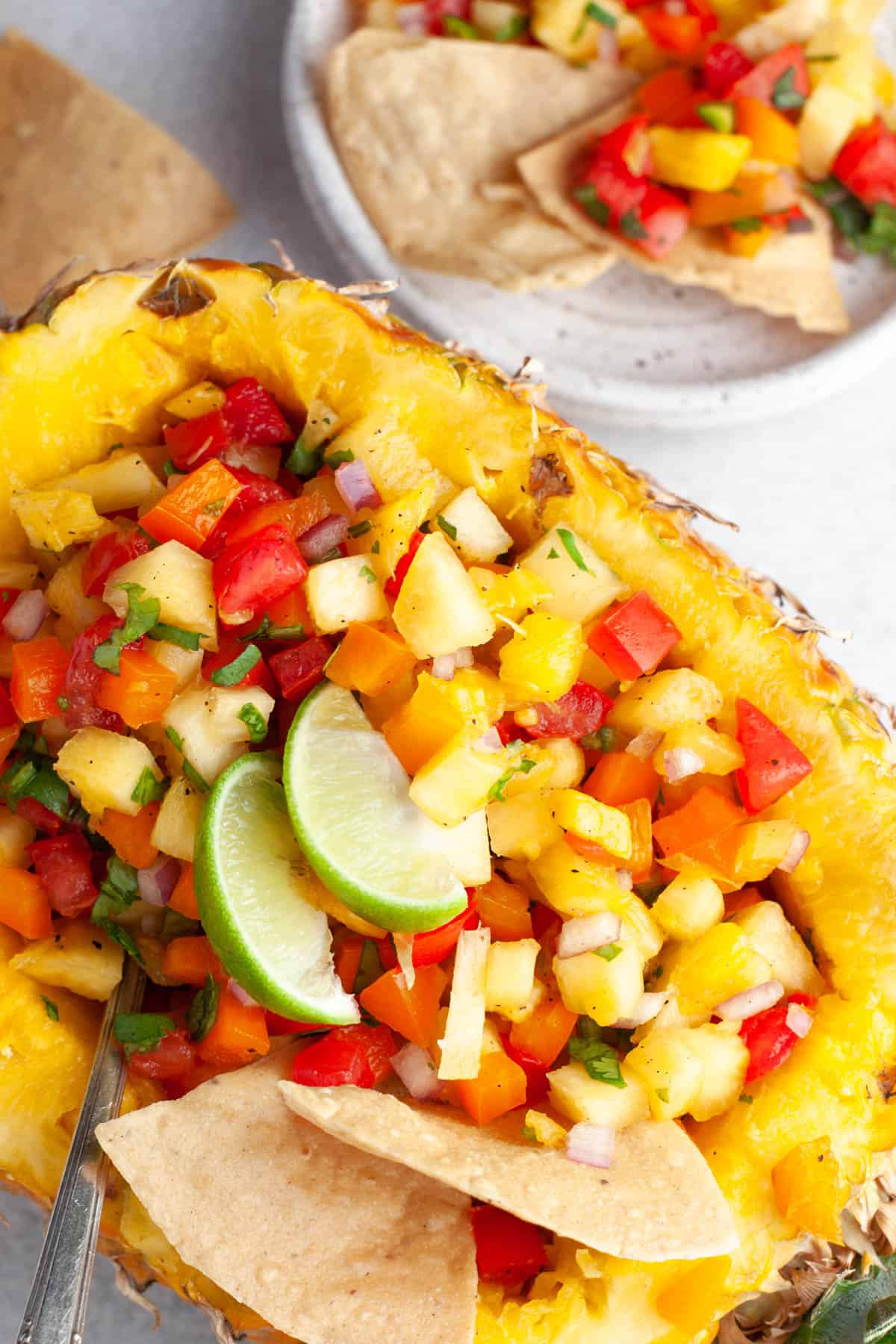 A pineapple bowl filled with fresh pineapple salsa.