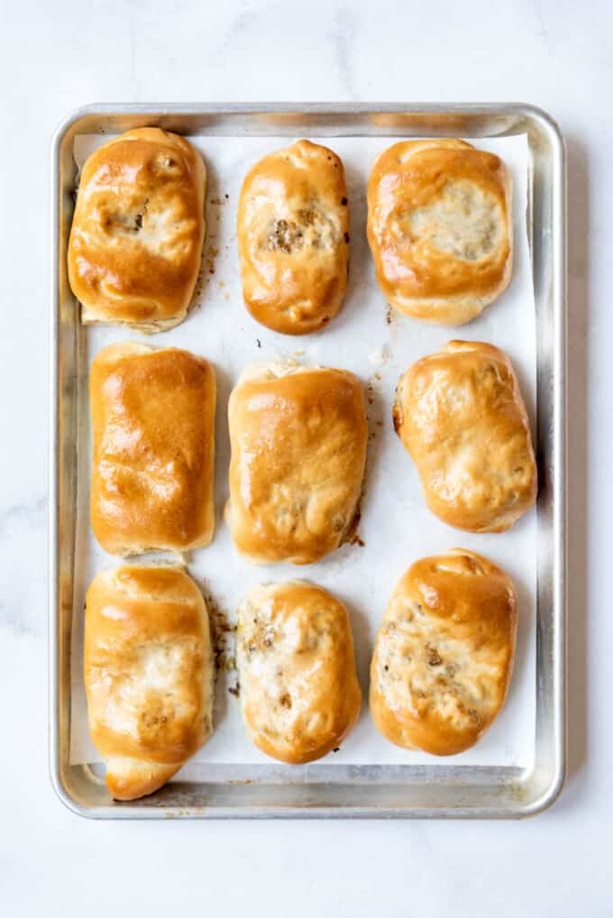Baked runzas on a baking sheet lined with parchment paper.