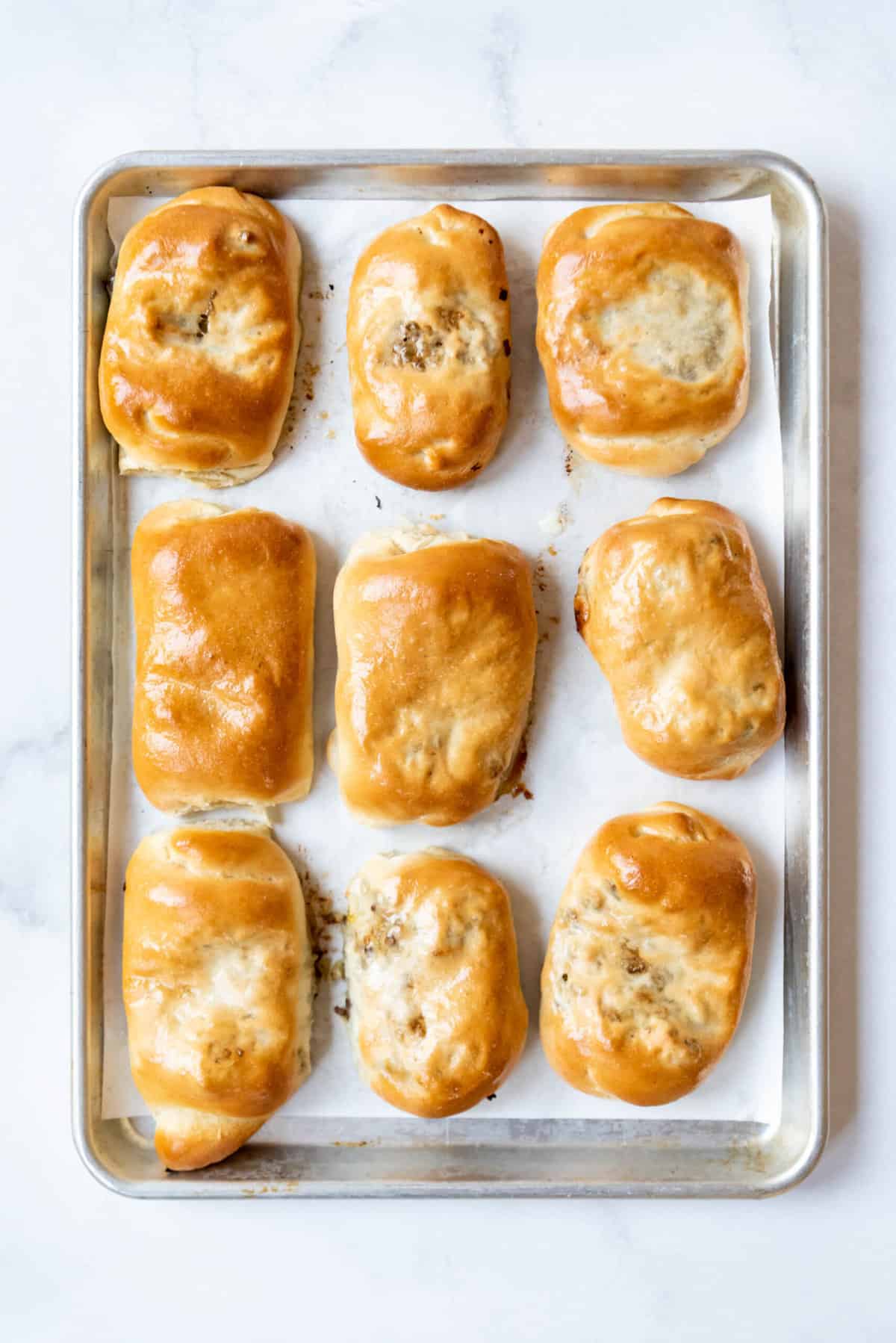 Baked runzas on a baking sheet lined with parchment paper.