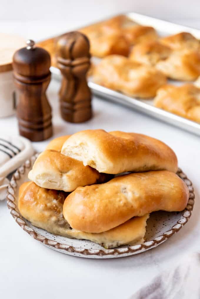 A plate of homemade runzas in front of salt and pepper shakers.