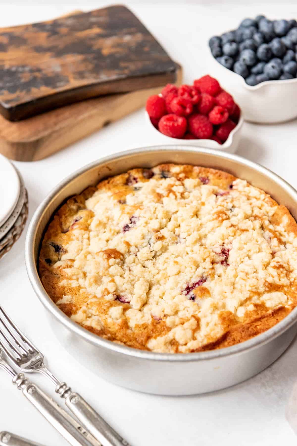 Baked berry breakfast cake cooling in a pan.
