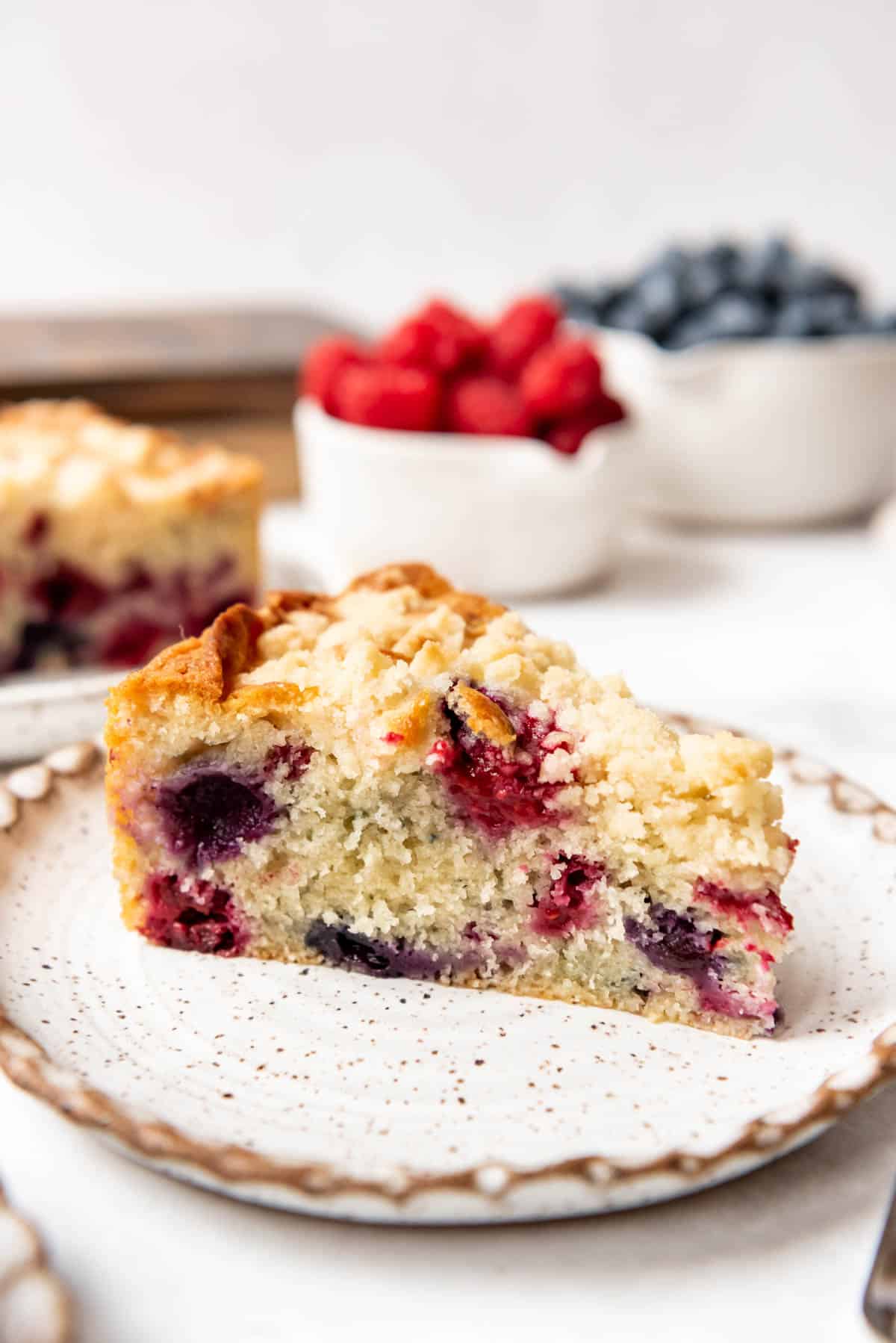 A slice of mixed berry breakfast cake on a plate.