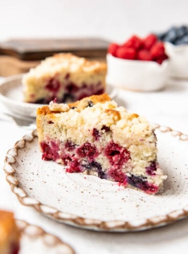 A slice of mixed berry breakfast cake on a plate.