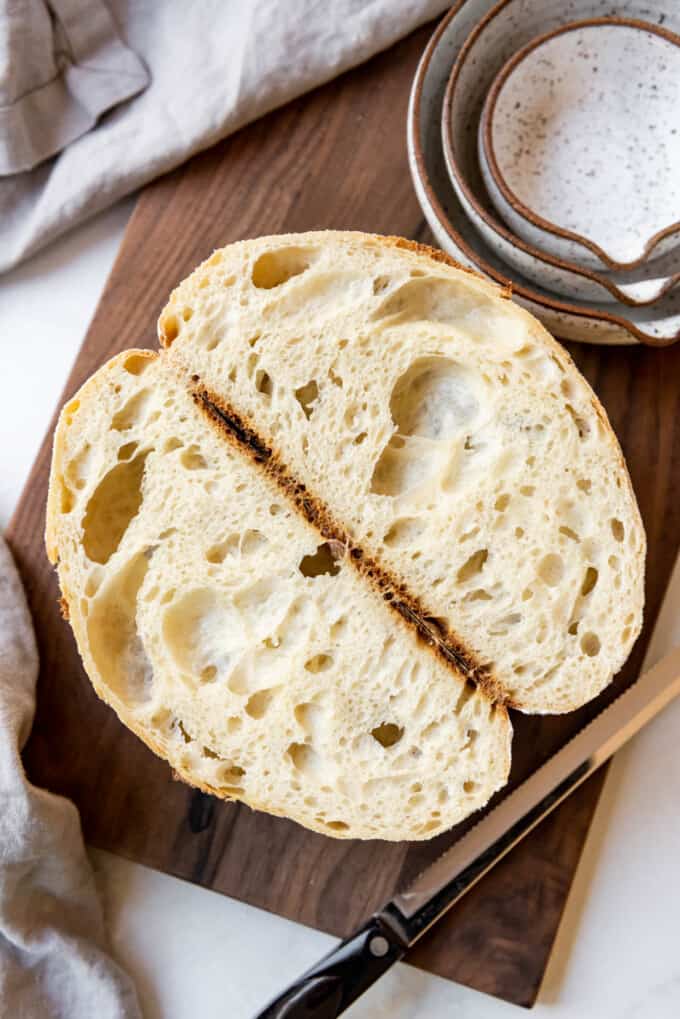 An overhead image of a loaf of sourdough bread that has been sliced in half.