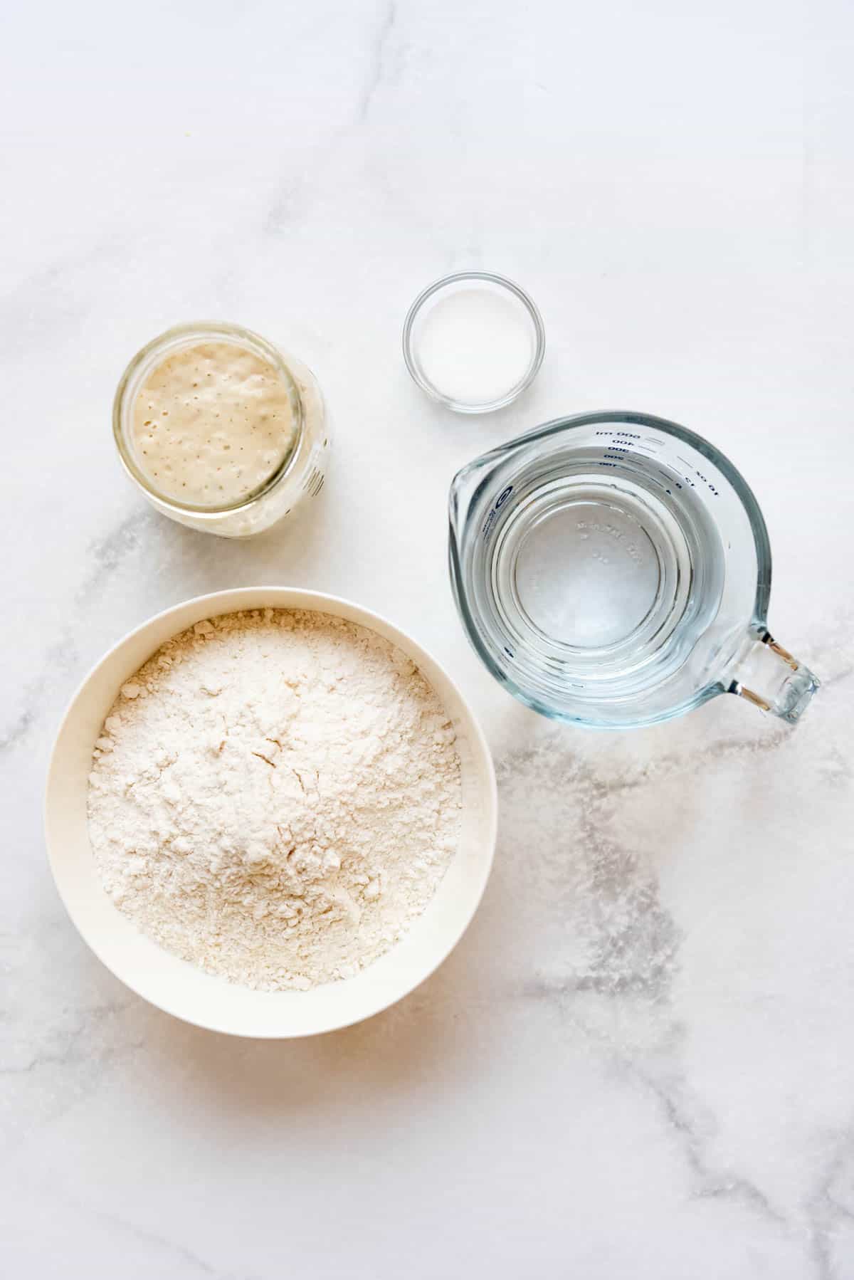 Ingredients for making homemade sourdough bread.