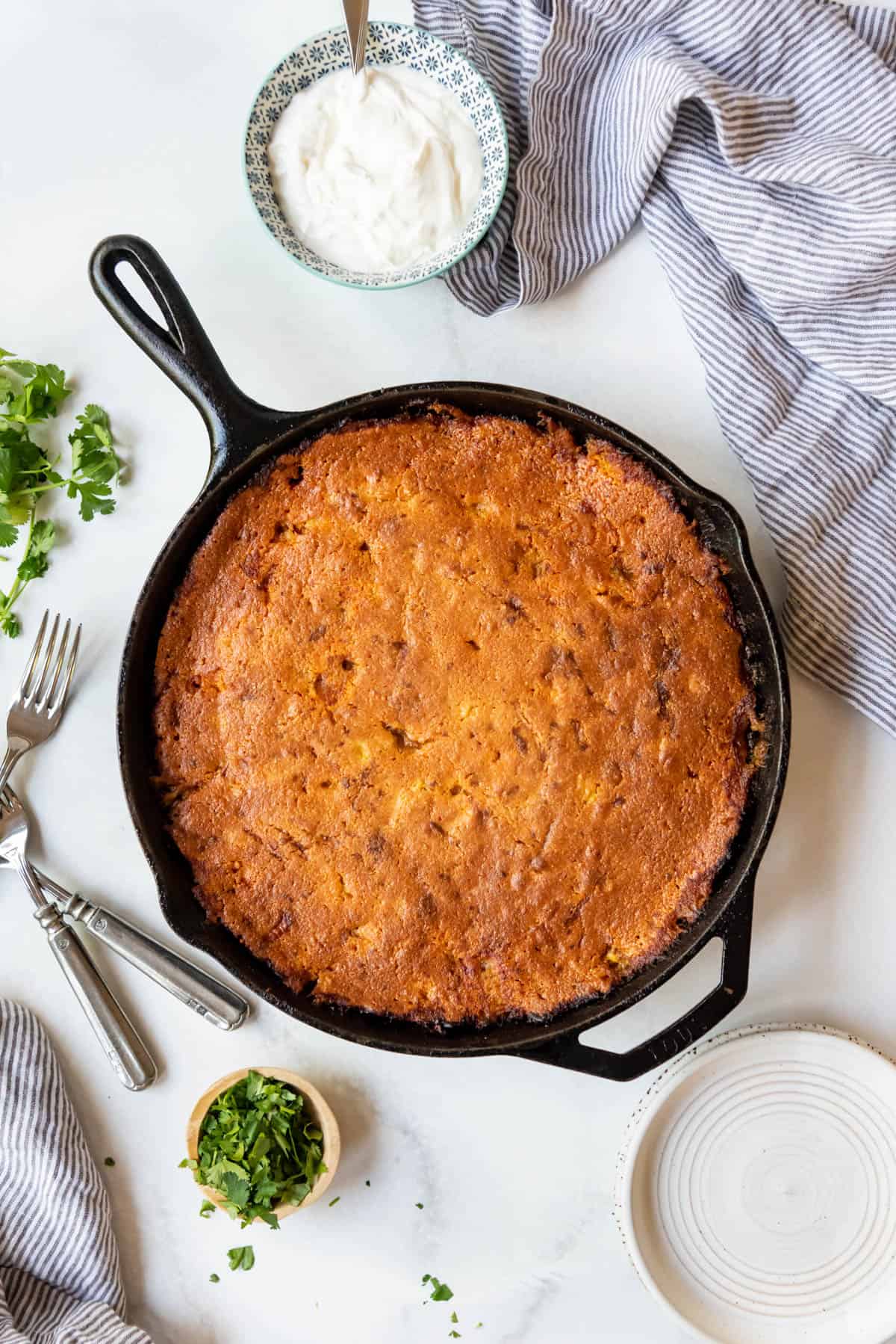 Baked tamale pie in a cast iron skillet.