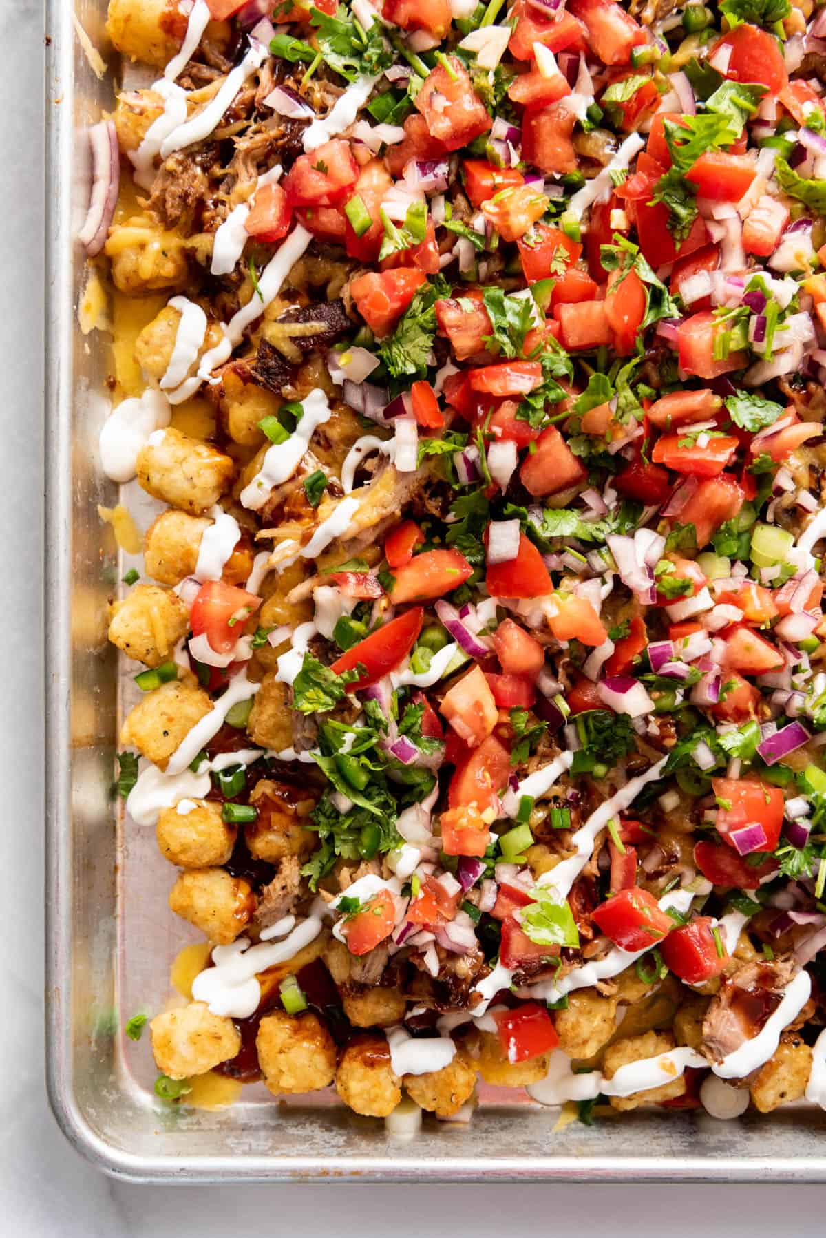 A close image of loaded tater tot nachos.