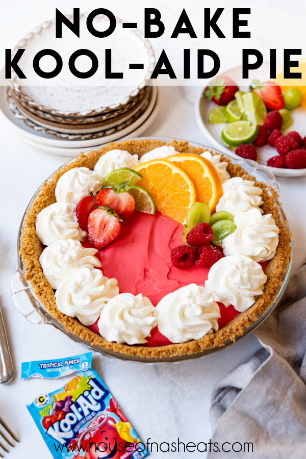 A Kool-Aid pie decorated with whipped cream and fresh fruit with text overlay.