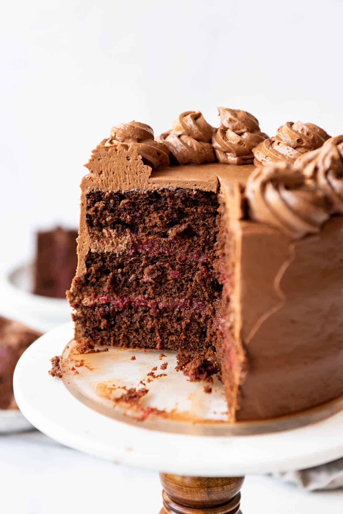 A close image of a three layer chocolate raspberry cake.