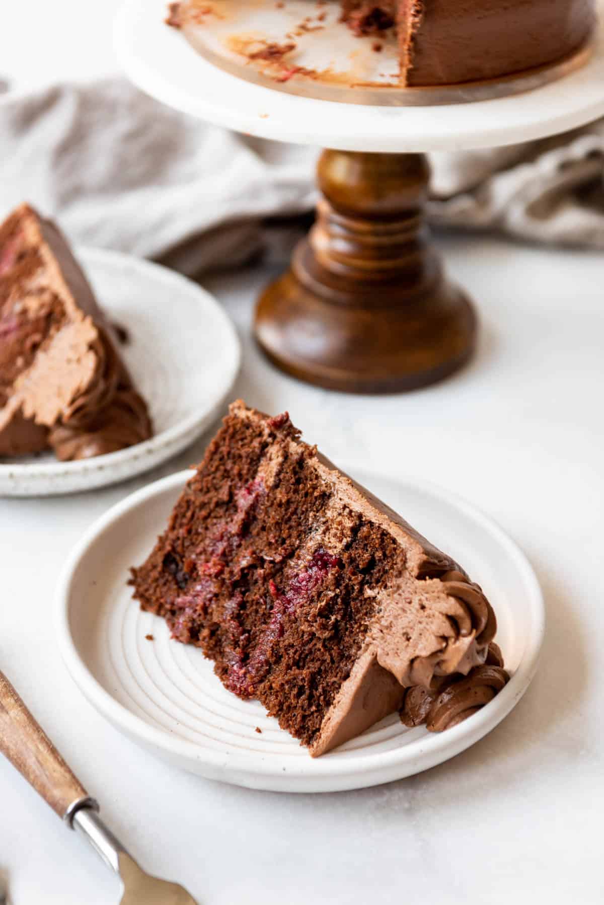 An image of a slice of homemade raspberry chocolate cake on a plate.