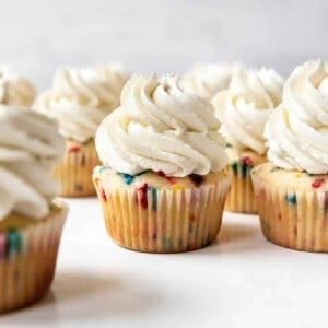 Cupcakes topped with swirls of Swiss meringue buttercream frosting.