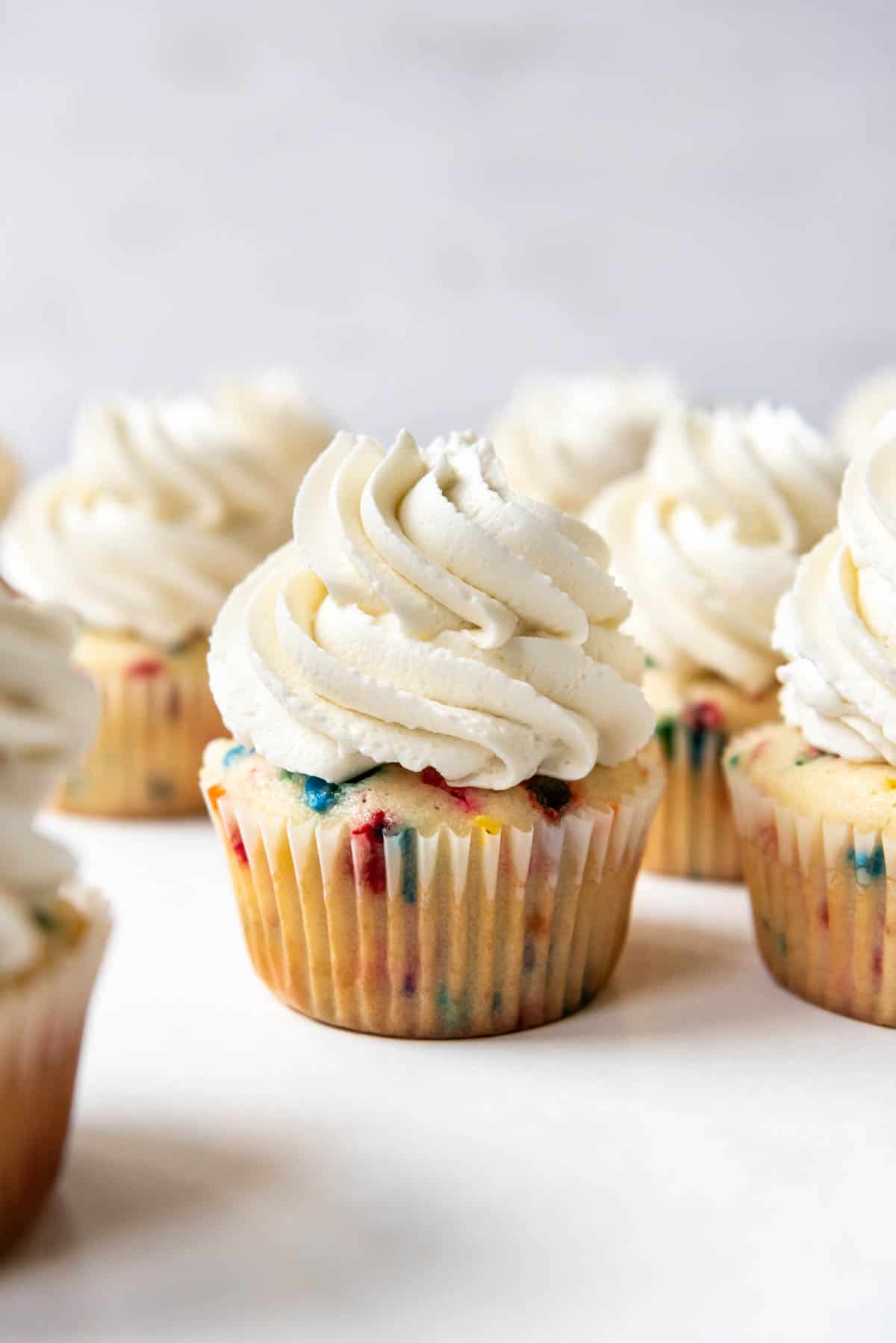 Cupcakes topped with swirls of Swiss meringue buttercream frosting.