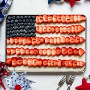 A 4th of July flag cake with fresh fruit decorations.
