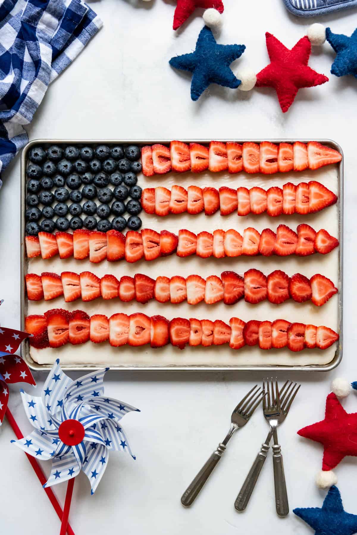 A 4th of July flag cake with fresh fruit decorations.