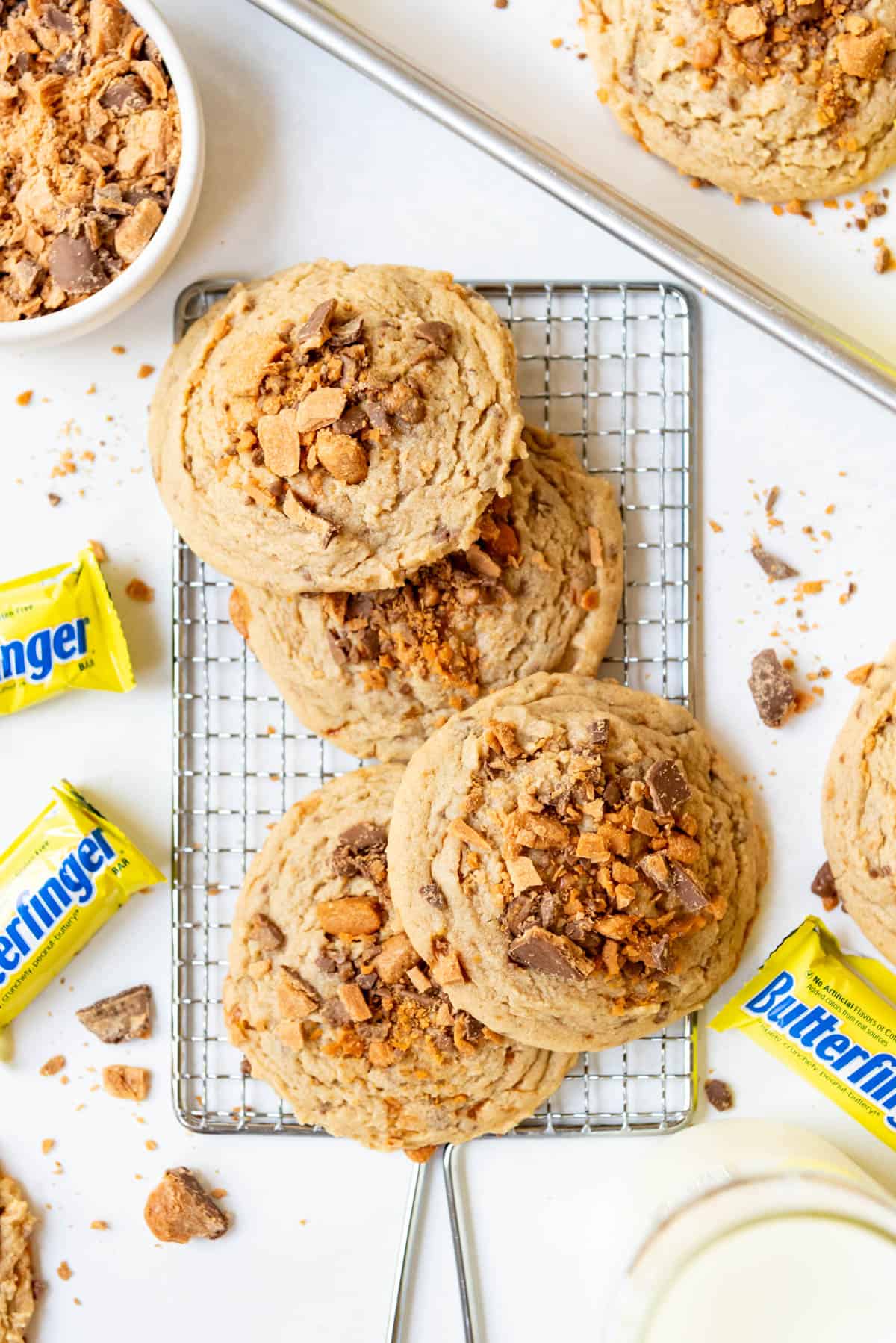 An overhead image of butterfingers cookies stacked haphazardly on top of each other.