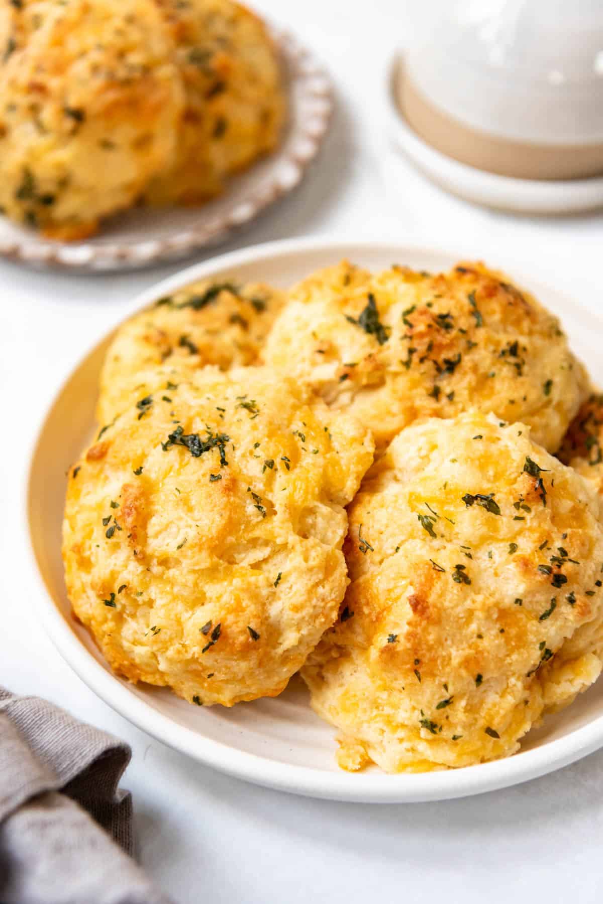 An image of cheddar bay biscuits piled on a plate.