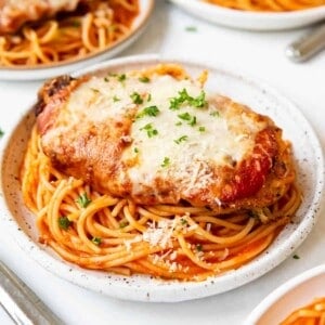 A plate of homemade chicken parmesan with spaghetti.