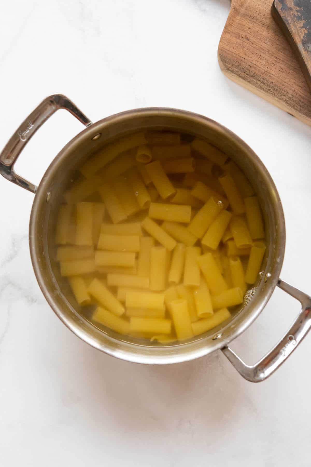 Cooking rigatoni pasta in salted water.