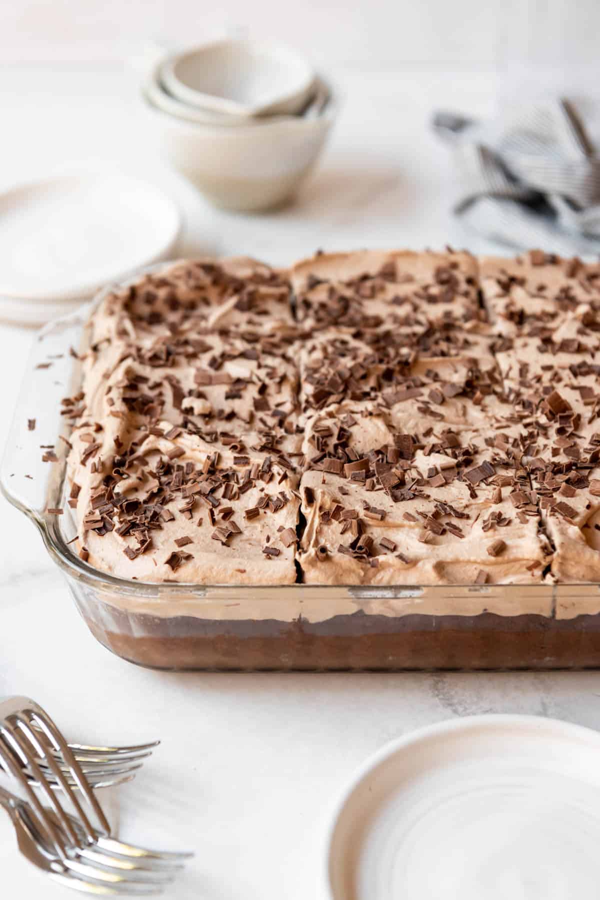 A chocolate tres leches cake with chocolate whipped cream on top.
