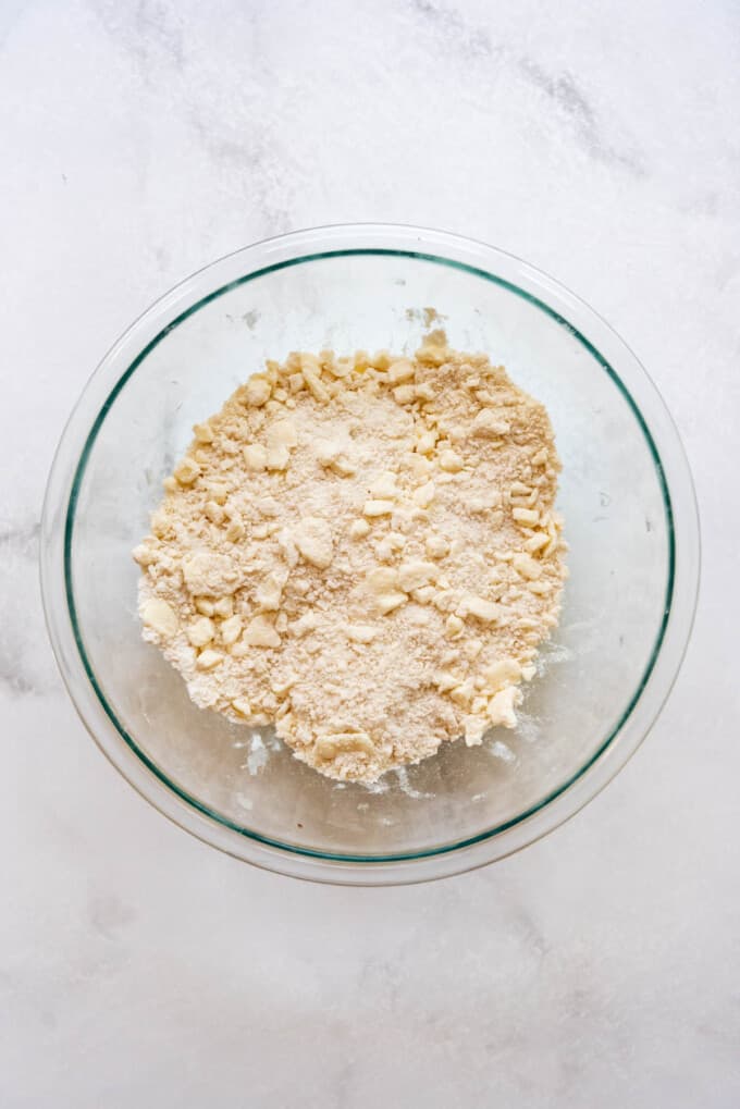 Pie crust ingredients with butter and shortening cut into the flour and salt.